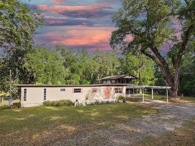 2780 County Road 575, Bushnell, FL 33513 - view of front facade with gravel driveway, a front yard, and a detached carport