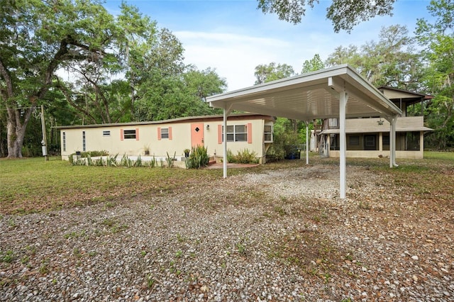 2780 County Road 575, Bushnell, FL 33513 - view of front of house with driveway, a front lawn, and a carport