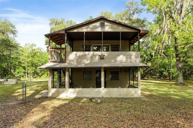 2780 County Road 575, Bushnell, FL 33513 - back of property with a balcony, a sunroom, fence, and a yard