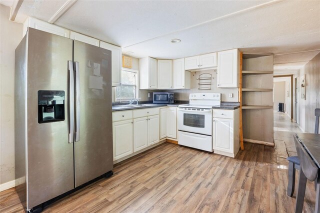 2780 County Road 575, Bushnell, FL 33513 - kitchen with light wood-style flooring, stainless steel appliances, dark countertops, white cabinetry, and open shelves