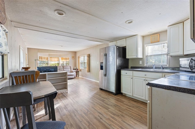 2780 County Road 575, Bushnell, FL 33513 - kitchen featuring dark countertops, appliances with stainless steel finishes, beamed ceiling, and light wood finished floors