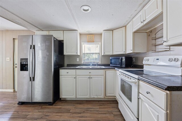 2780 County Road 575, Bushnell, FL 33513 - kitchen with dark countertops, dark wood-style flooring, a sink, and stainless steel appliances