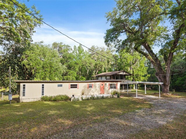 2780 County Road 575, Bushnell, FL 33513 - view of front facade featuring driveway, a front yard, and a carport