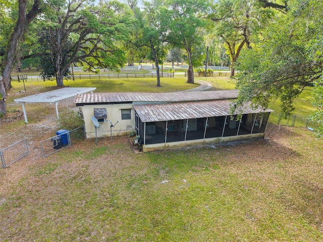 2780 County Road 575, Bushnell, FL 33513 - rear view of house with a sunroom, fence, and a yard