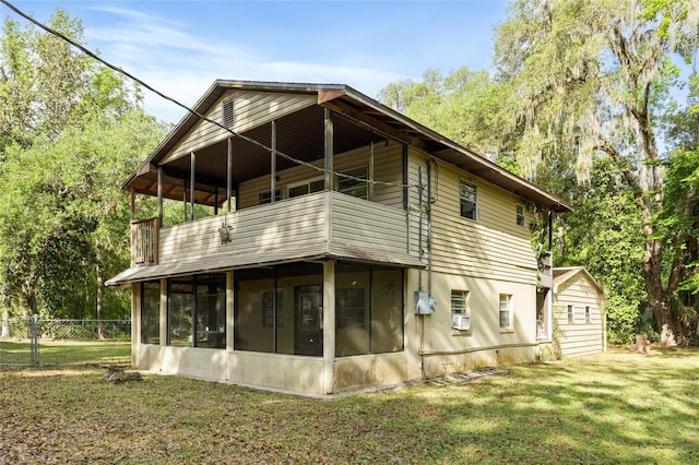 2780 County Road 575, Bushnell, FL 33513 - rear view of house featuring a lawn, a sunroom, fence, and a balcony