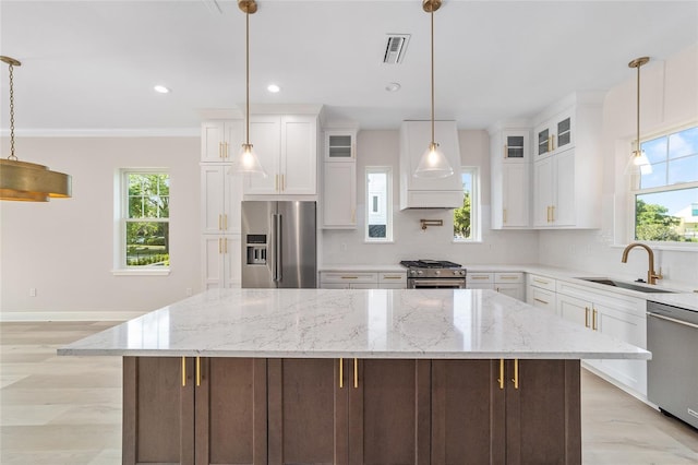 129 SE Watula Ave, Ocala, FL 34471 - kitchen featuring tasteful backsplash, a kitchen island, white cabinets, stainless steel appliances, and a sink