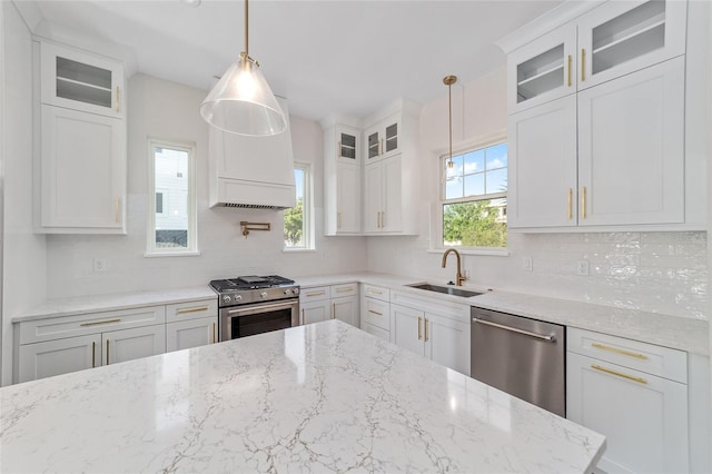 129 SE Watula Ave, Ocala, FL 34471 - kitchen featuring a sink, decorative backsplash, appliances with stainless steel finishes, and white cabinets
