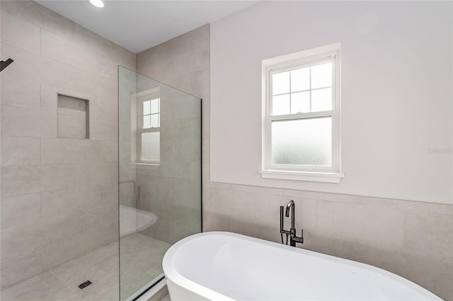 129 SE Watula Ave, Ocala, FL 34471 - full bath with a freestanding bath, tile walls, and a tile shower