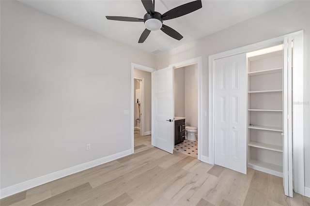 129 SE Watula Ave, Ocala, FL 34471 - unfurnished bedroom featuring a closet, baseboards, ceiling fan, and light wood-style floors