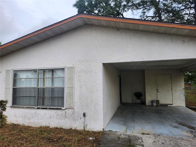 view of side of home featuring stucco siding