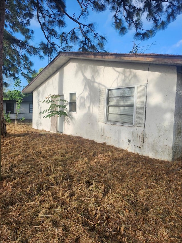 view of side of home with stucco siding