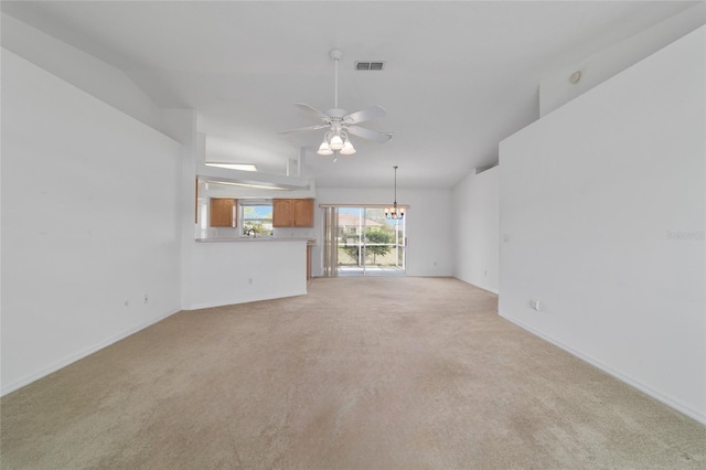 unfurnished living room featuring light carpet, ceiling fan with notable chandelier, baseboards, and visible vents