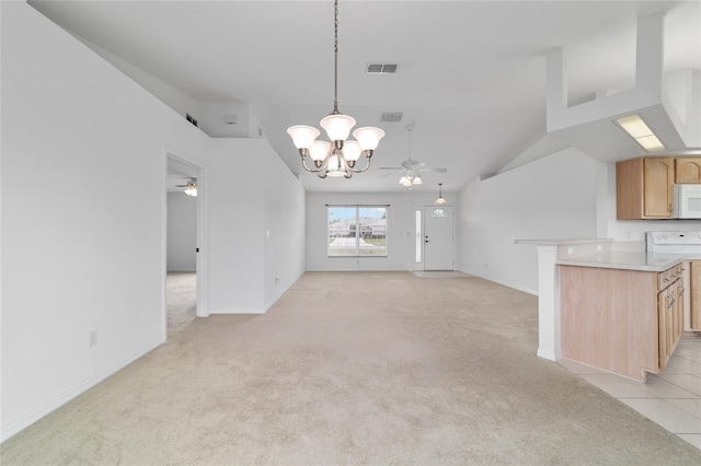 unfurnished living room with visible vents, ceiling fan with notable chandelier, and light colored carpet
