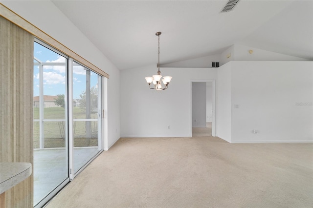 spare room with vaulted ceiling, light carpet, a chandelier, and visible vents