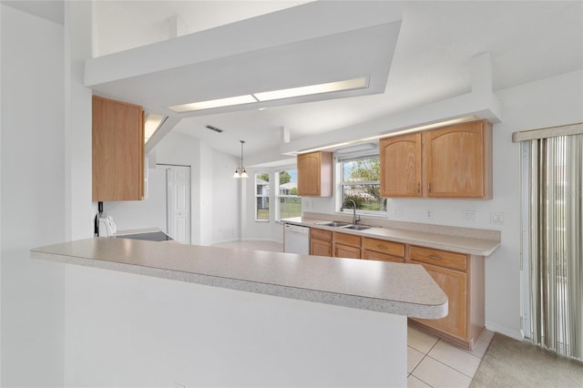 kitchen with light countertops, light tile patterned floors, a sink, a peninsula, and white dishwasher