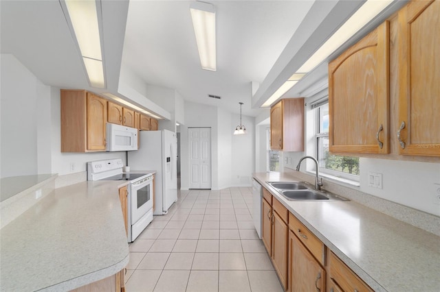 kitchen with light countertops, light tile patterned floors, a sink, and white appliances