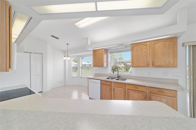 kitchen featuring light countertops, a sink, light tile patterned flooring, visible vents, and white dishwasher