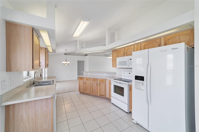 kitchen featuring light countertops, a peninsula, white appliances, a sink, and light tile patterned floors
