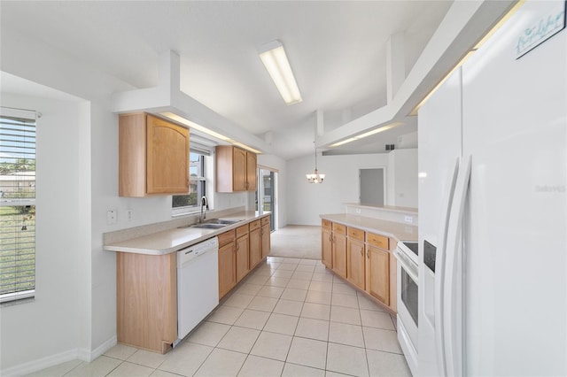 kitchen featuring light countertops, a chandelier, white appliances, a sink, and light tile patterned floors