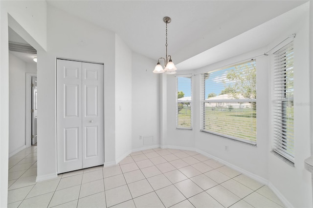 unfurnished dining area with light tile patterned flooring, baseboards, and a chandelier