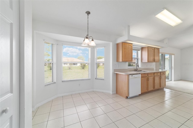 kitchen with light countertops, a sink, dishwasher, hanging light fixtures, and baseboards