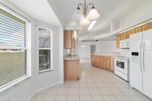 kitchen with a notable chandelier, light countertops, a sink, light tile patterned floors, and white appliances