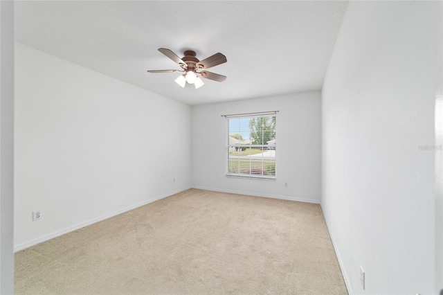 empty room with light carpet, baseboards, and ceiling fan