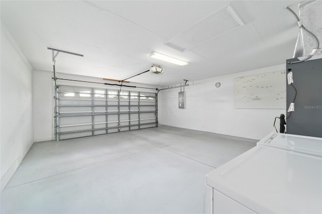 garage featuring electric panel and a garage door opener