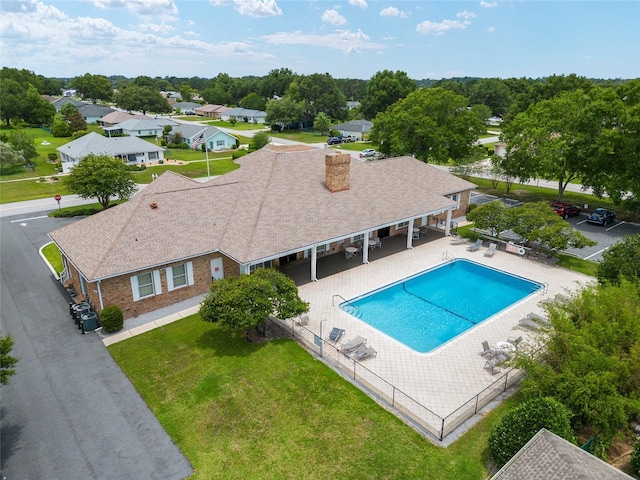 pool with a patio, a fenced backyard, and a yard