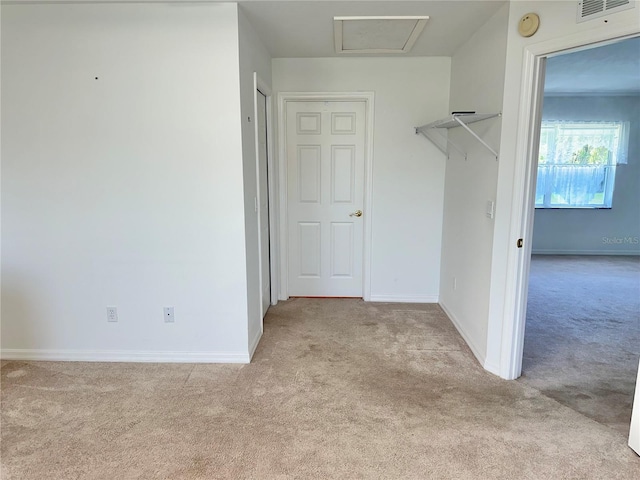 walk in closet with visible vents and light colored carpet