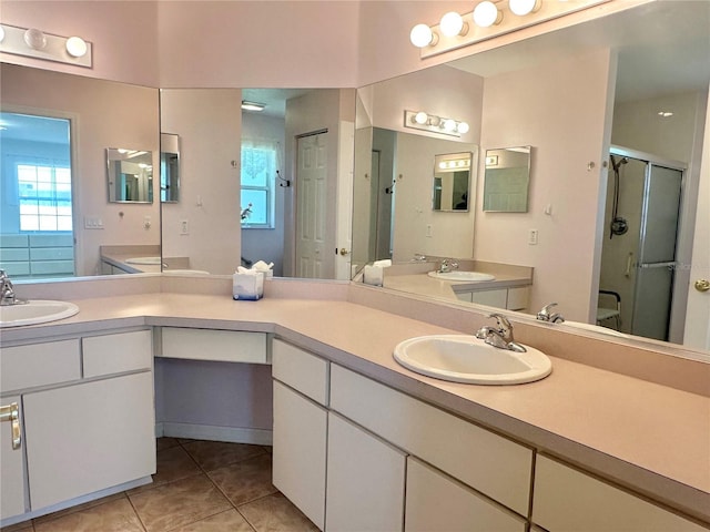 full bathroom featuring a stall shower, tile patterned floors, and vanity