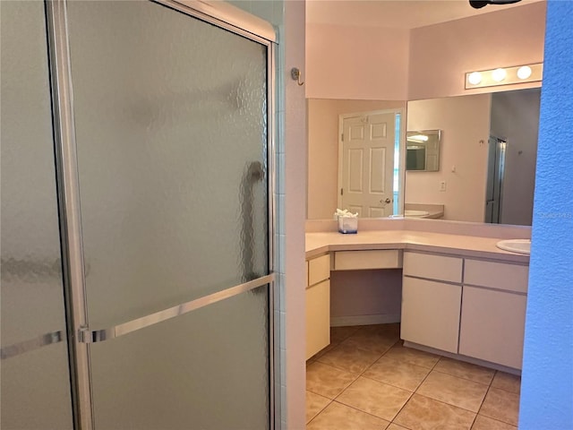 full bathroom with tile patterned floors, vanity, and a shower stall