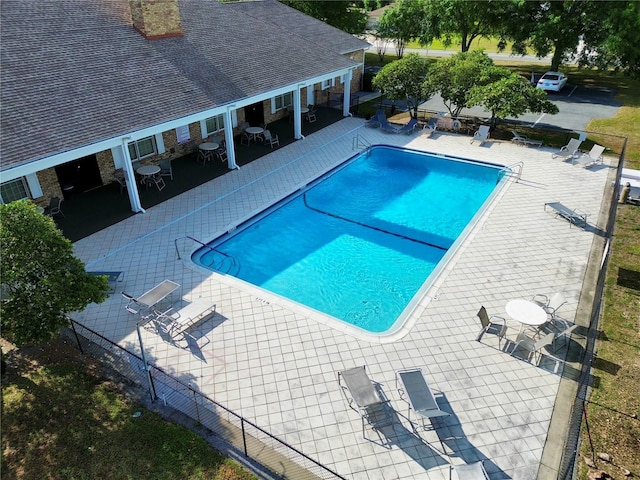 pool featuring fence and a patio