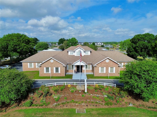 view of front of property with fence and brick siding