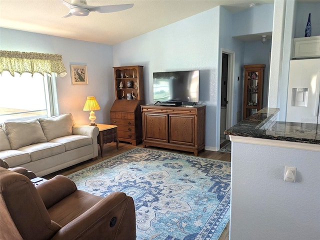 living room featuring lofted ceiling, wood finished floors, and ceiling fan