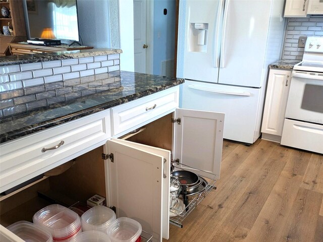 kitchen featuring light wood-type flooring, white cabinetry, white appliances, and decorative backsplash