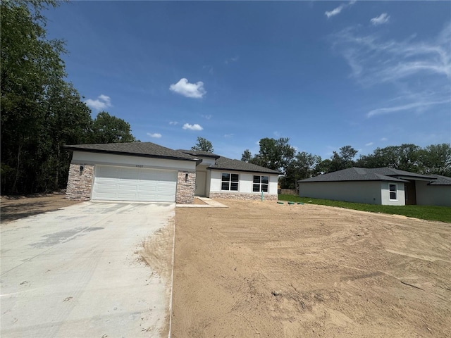 11537 SW 59th Ter, Ocala, FL 34476 - prairie-style home with concrete driveway, a garage, stone siding, and stucco siding