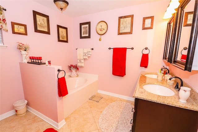 full bath with a sink, baseboards, tile patterned flooring, and a garden tub