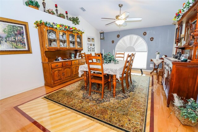 dining space featuring visible vents, baseboards, a ceiling fan, and light wood finished floors