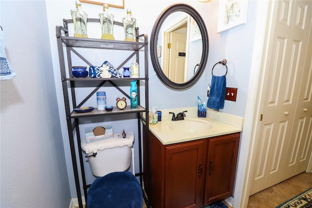 bathroom with toilet and vanity
