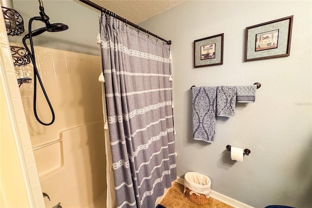 full bath featuring baseboards