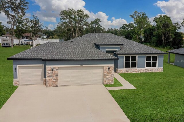 9552 SW 40th Ter, Ocala, FL 34476 - view of front of home featuring stone siding, roof with shingles, an attached garage, and a front lawn