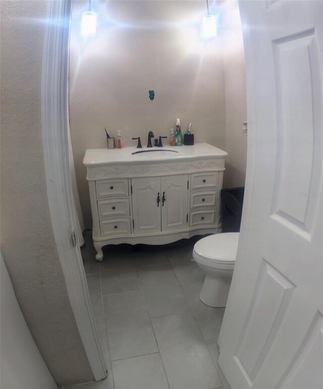 bathroom featuring tile patterned floors, vanity, and toilet