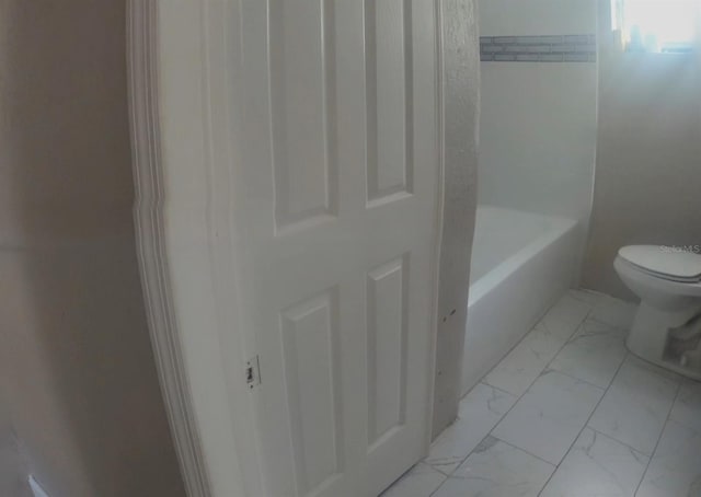 full bath featuring a bathing tub, walk in shower, marble finish floor, and toilet