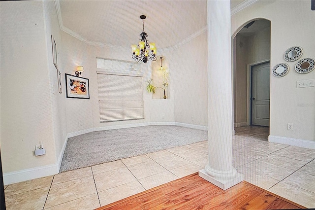 interior space with crown molding, carpet flooring, tile patterned floors, arched walkways, and a notable chandelier