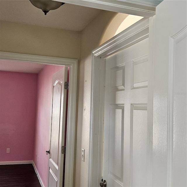 hall featuring baseboards