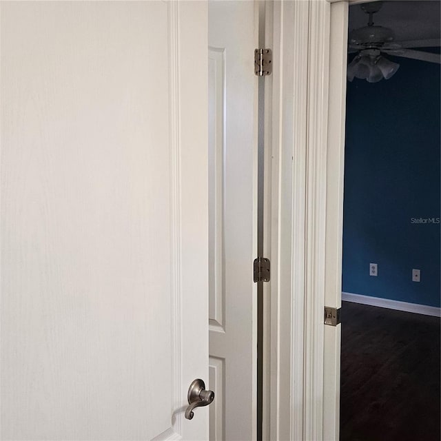 interior details with baseboards and ceiling fan