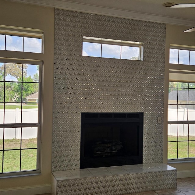 room details featuring ornamental molding and a high end fireplace