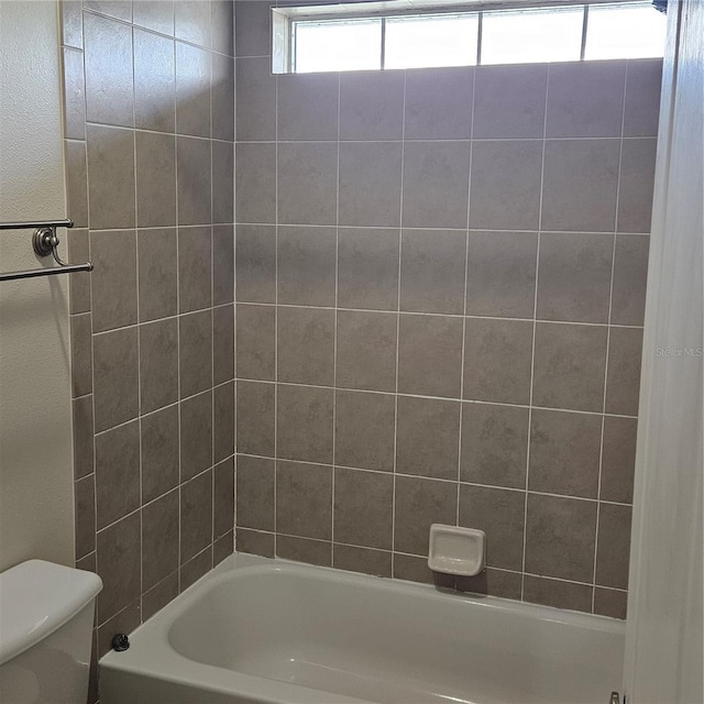 bathroom with shower / washtub combination and toilet