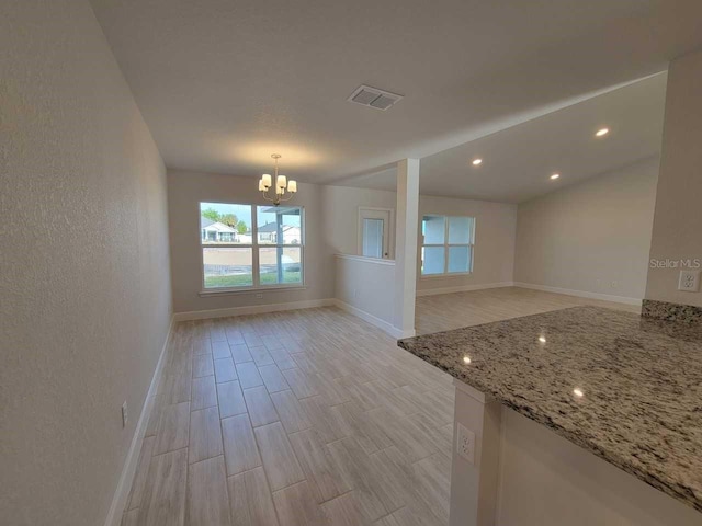 9553 SW 42nd Ave, Ocala, FL 34476 - spare room featuring a chandelier, baseboards, and light wood-type flooring
